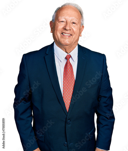 Senior man with grey hair wearing business suit and tie with a happy and cool smile on face. lucky person.