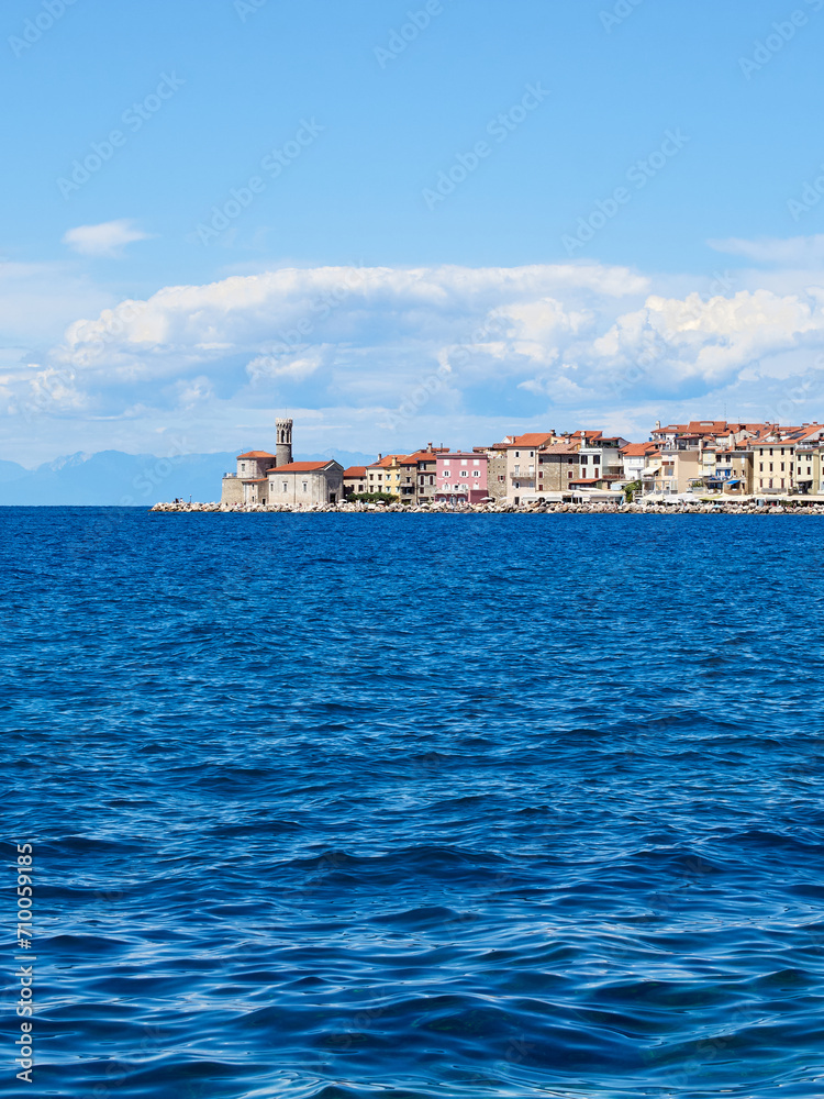View of Piran, a charming coastal town in the Adriatic sea with beautiful buildings and the church of St. Clement. Istria, Slovenia, Europe