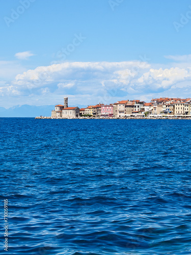 View of Piran, a charming coastal town in the Adriatic sea with beautiful buildings and the church of St. Clement. Istria, Slovenia, Europe
