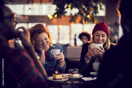 Smiling young diverse people sitting in cafe photo