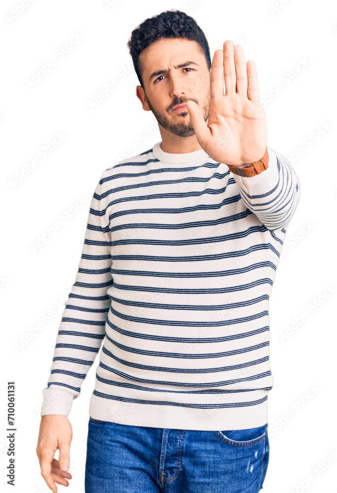 Young hispanic man wearing casual clothes doing stop sing with palm of the hand. warning expression with negative and serious gesture on the face. Young hispanic man wearing casual clothes doing stop sing with palm of the hand. warning expression with negative and serious gesture on the face.
