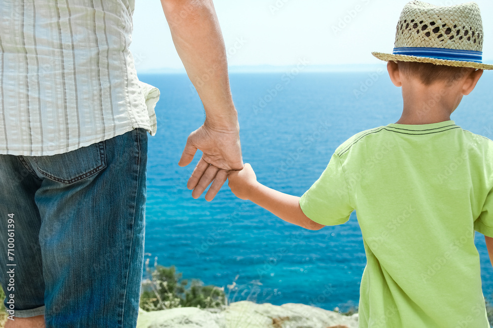 A hands of happy parents and children at sea in travel background in greece A hands of happy parents and children at sea in travel background in greece