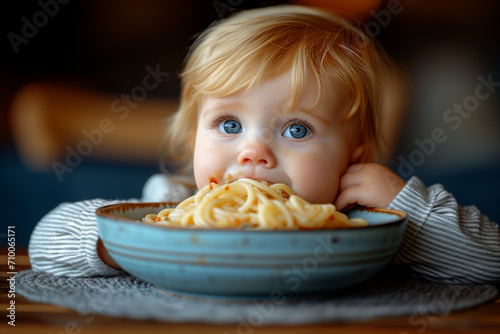 little baby eating pasta