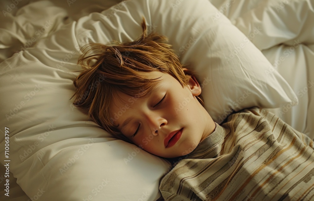 a small boy sleeping on a white pillow a small boy sleeping on a white pillow