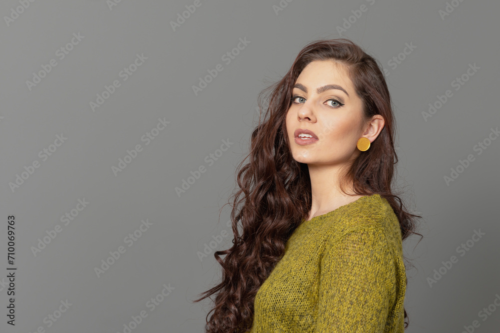 close-up portrait of beautiful sensual female with long curly hair against gray background close-up portrait of beautiful sensual female with long curly hair against gray background