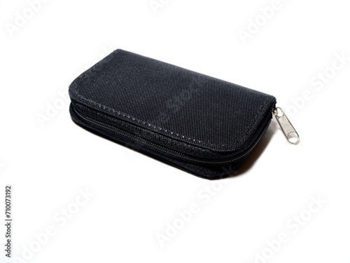 Memory card case on isolated white background. Small black SD card storage box for digital cameras.