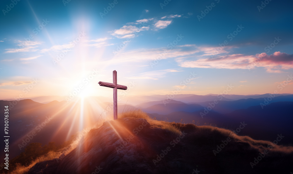 Wooden cross on hill top with sun shining bright behind, redemption concept