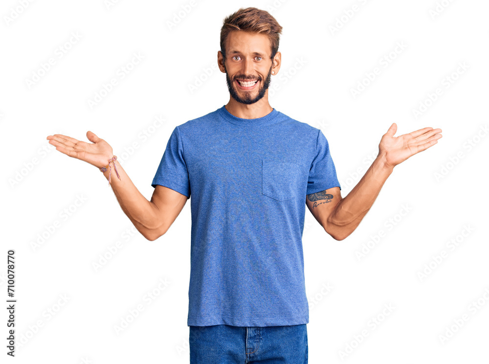 Fototapeta premium Handsome blond man with beard wearing casual clothes celebrating victory with happy smile and winner expression with raised hands