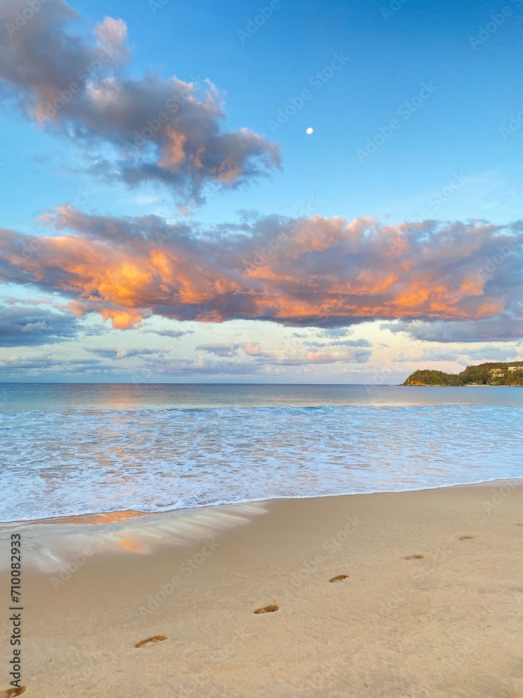 Beach at sunset. Magnificent view of mountains and rosy and blue sky. Ocean view at low tide. Dawn on the beach. Waves curling on the sand. Sunrise on a beach. Beach at sunset. Magnificent view of mountains and rosy and blue sky. Ocean view at low tide. Dawn on the beach. Waves curling on the sand. Sunrise on a beach.