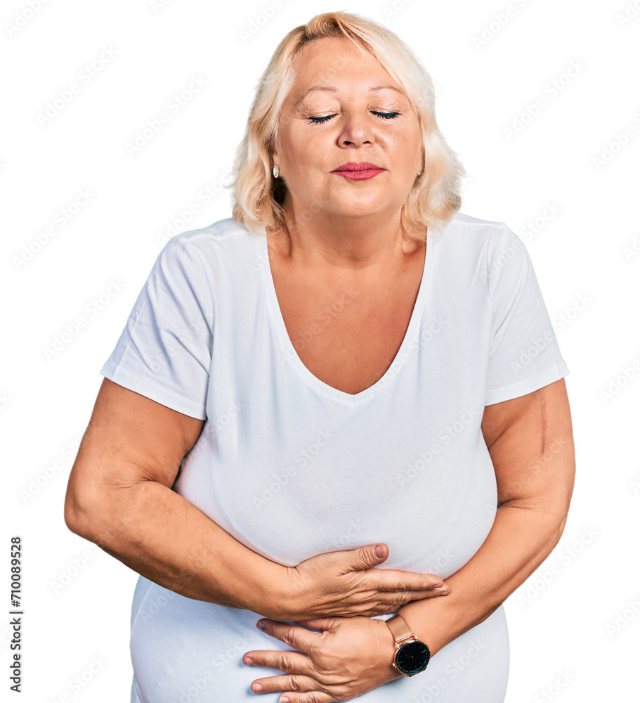 Middle age blonde woman wearing casual white t shirt with hand on stomach because indigestion, painful illness feeling unwell. ache concept. Middle age blonde woman wearing casual white t shirt with hand on stomach because indigestion, painful illness feeling unwell. ache concept.
