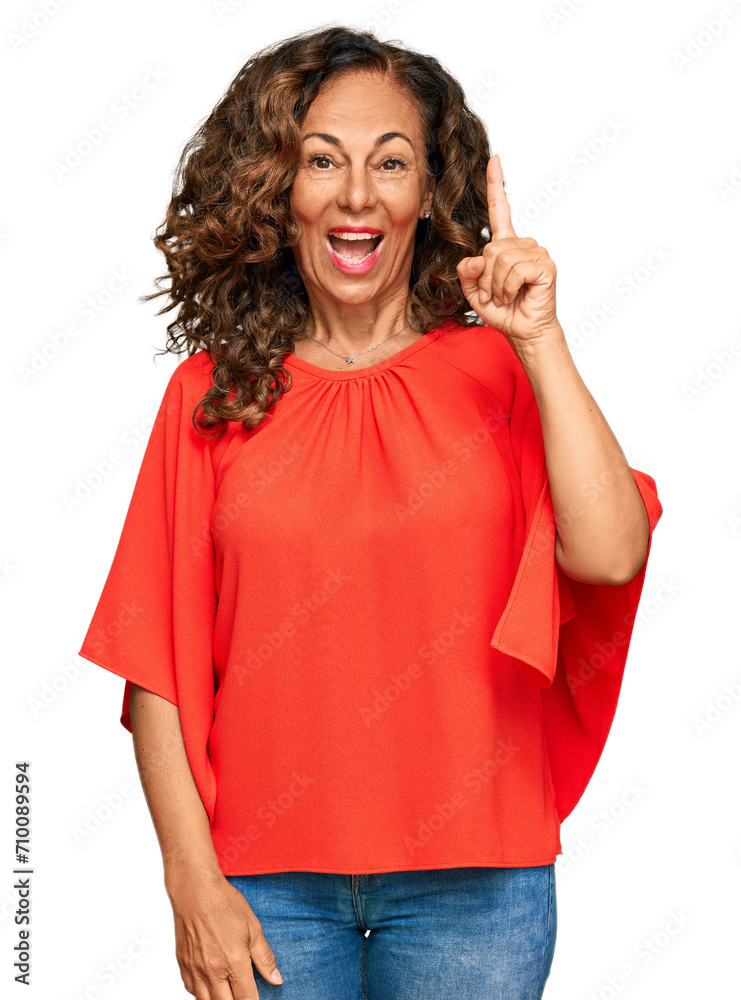 Middle age hispanic woman wearing casual clothes pointing finger up with successful idea. exited and happy. number one. Middle age hispanic woman wearing casual clothes pointing finger up with successful idea. exited and happy. number one.
