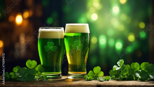 Glasses with green beer, clover leaves background pub