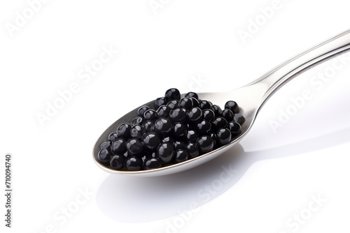 Fresh black caviar in spoon on white background