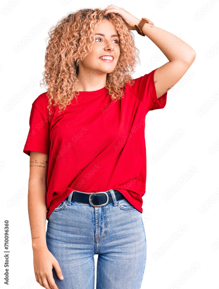 Young blonde woman with curly hair wearing casual red tshirt smiling confident touching hair with hand up gesture, posing attractive and fashionable Young blonde woman with curly hair wearing casual red tshirt smiling confident touching hair with hand up gesture, posing attractive and fashionable