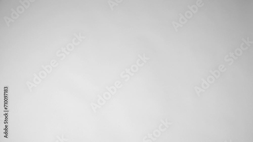 Slow motion of shoes falling down against a white background. Slow motion of women's thick sole sneakers falling down against a white background.  photo