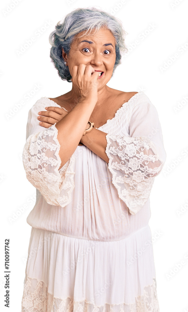 Senior woman with gray hair wearing bohemian style looking stressed and nervous with hands on mouth biting nails. anxiety problem.