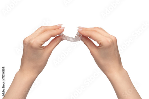 Transparent mouth guard in a woman's hand isolated. photo