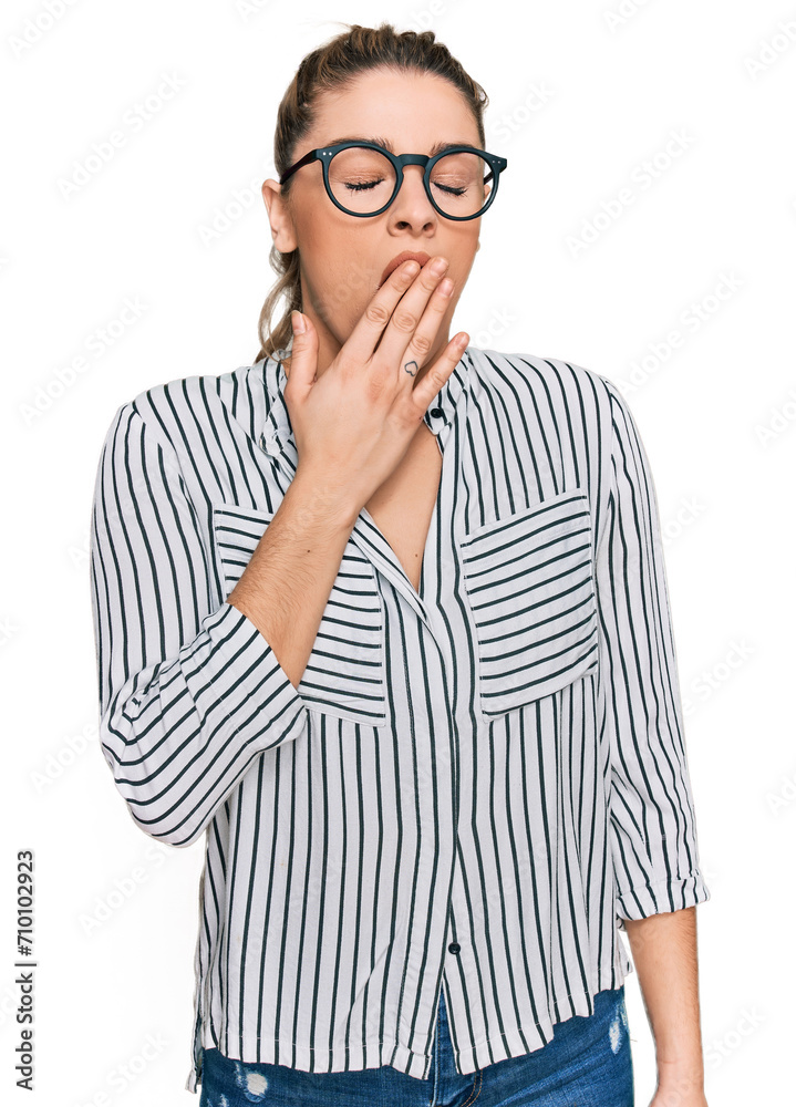 Young caucasian woman wearing business shirt and glasses bored yawning tired covering mouth with hand. restless and sleepiness. Young caucasian woman wearing business shirt and glasses bored yawning tired covering mouth with hand. restless and sleepiness.