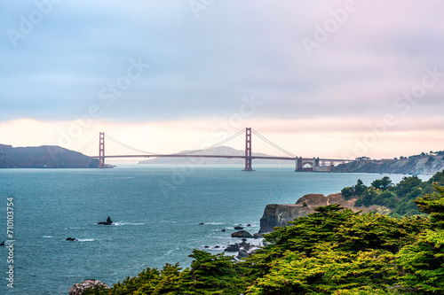 View of Golden Gate Bridge, in the evening. Photo taken from Lands End trial. Lands End is a park in San Francisco, CA within the Golden Gate National Recreation Area.