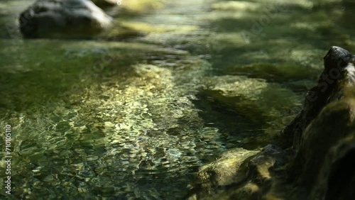 A sunlight spot on a mountain stream in summer (slow motion) photo