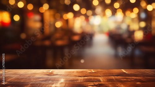 Wooden table in front of abstract blurred restaurant lights background photo