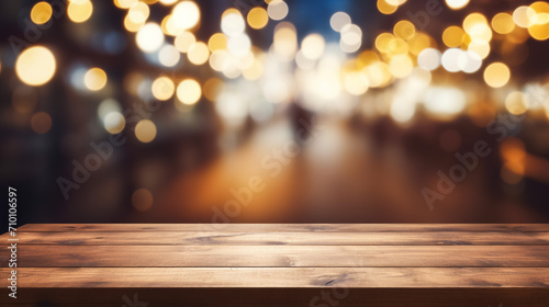 Wooden table in front of abstract blurred restaurant lights background