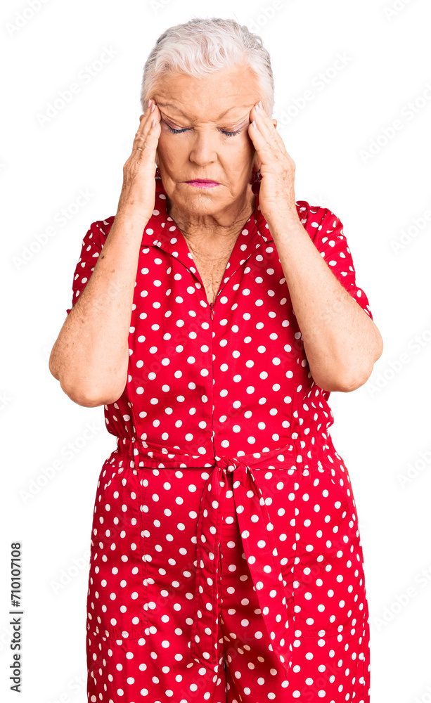 Senior beautiful woman with blue eyes and grey hair wearing a red summer dress with hand on head for pain in head because stress. suffering migraine. Senior beautiful woman with blue eyes and grey hair wearing a red summer dress with hand on head for pain in head because stress. suffering migraine.