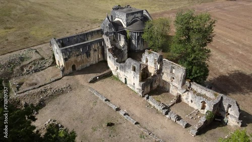 Aerial drone view of old ruins of small abbey a type of monastery used by members of a religious order under the governance of an abbot or abbess they provide a complex of buildings and land 4k photo