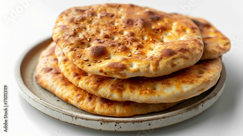 Pita bread on a plate on a white background. Shallow dof.