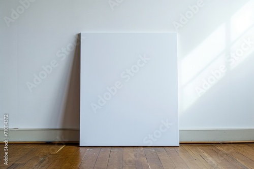 blank vertical canvas  white wall and laminate wooden floor on background  poster mock up