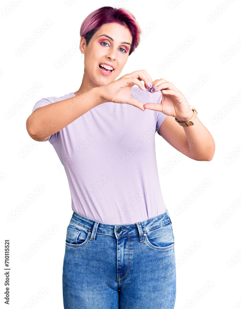 Young beautiful woman with pink hair wearing casual clothes smiling in love doing heart symbol shape with hands. romantic concept. Young beautiful woman with pink hair wearing casual clothes smiling in love doing heart symbol shape with hands. romantic concept.