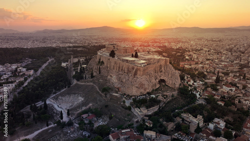 Aerial drone photo of iconic Acropolis hill and the unique masterpiece of Ancient world the Parthenon at sunset with beautiful golden colours, Athens historic centre, Attica, Greece