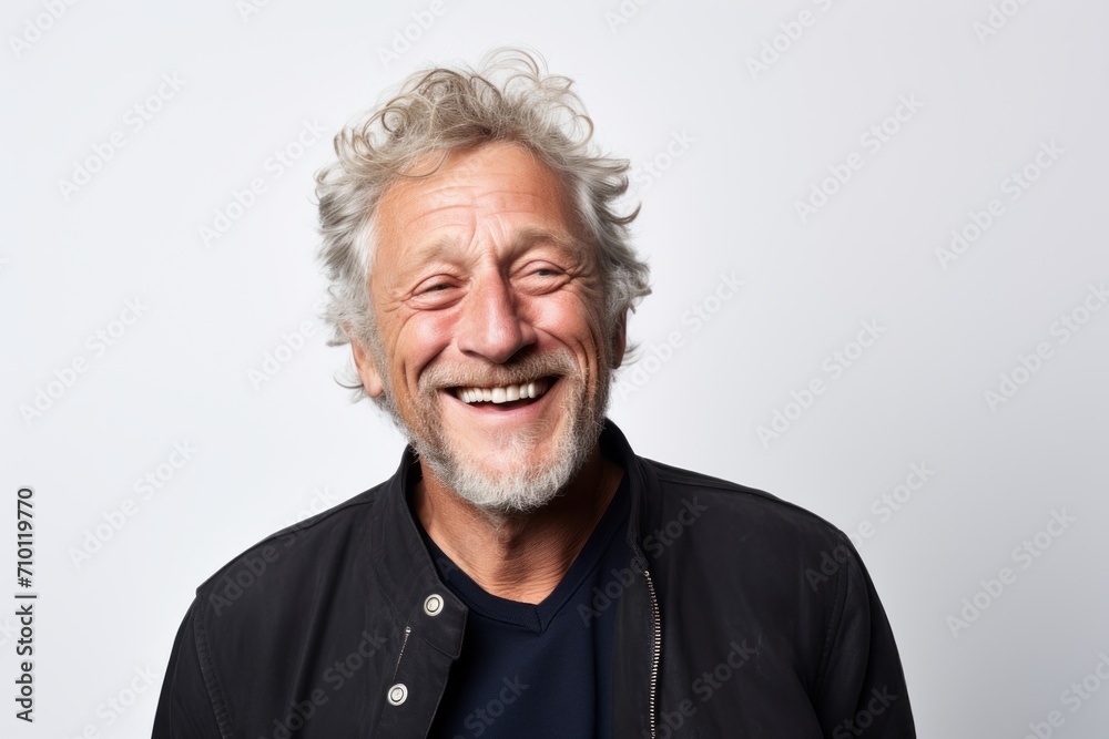 Portrait of a happy senior man laughing against a white background. Portrait of a happy senior man laughing against a white background.