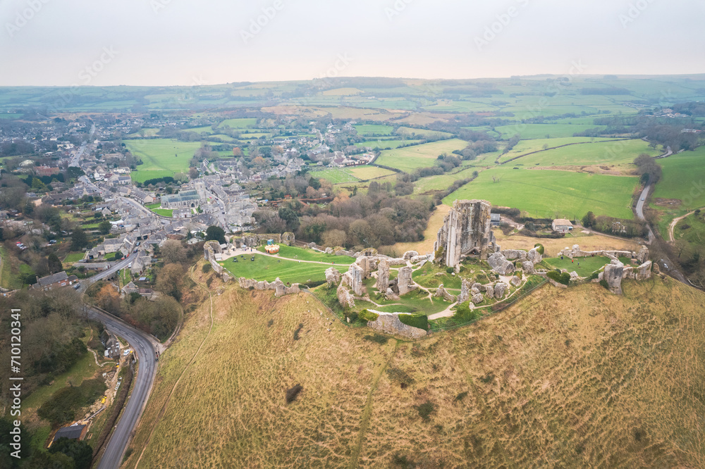amazing aerial view of Corfe Castle, aerial view of the famous historical site and the village, united kingdom.