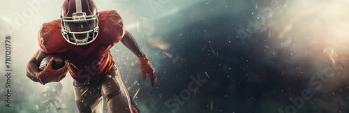 Dynamic image of an American football player in action on the field during a game, showcasing athletic prowess and determination under stadium lights. Banner with copy space.