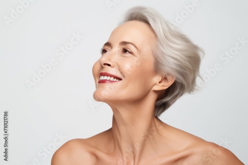 beauty  people and health concept - smiling middle aged woman over grey background