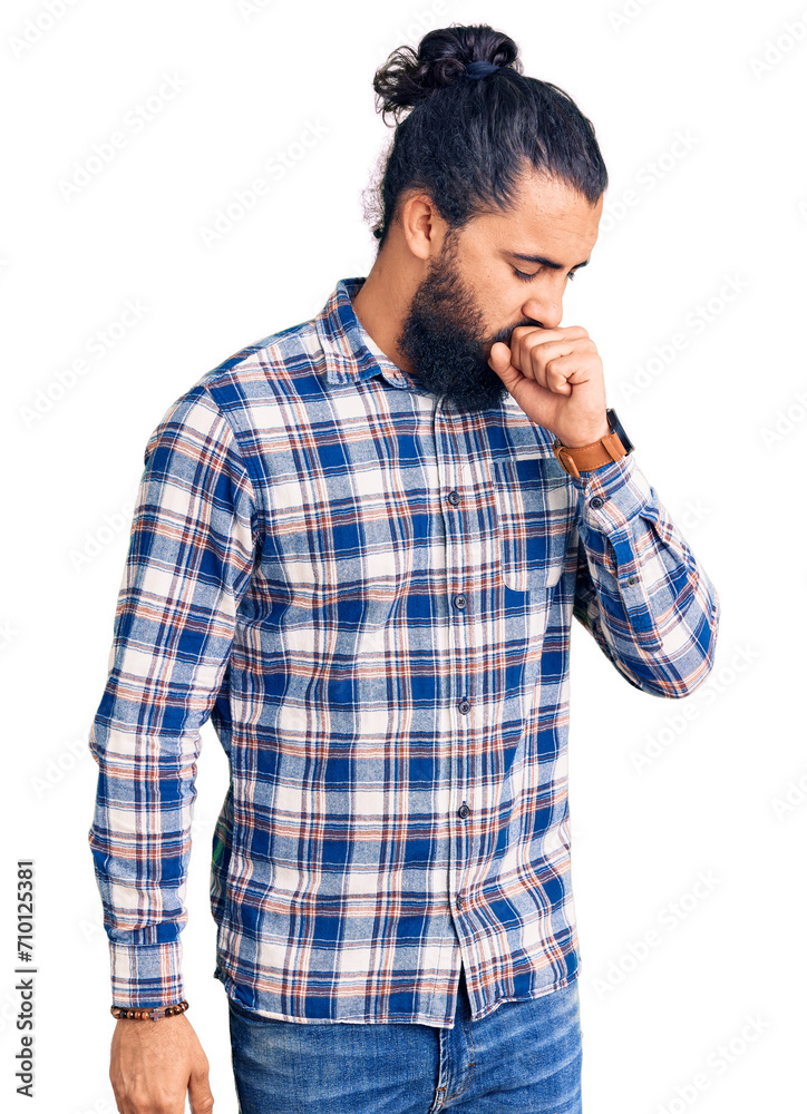 Young arab man wearing casual clothes feeling unwell and coughing as symptom for cold or bronchitis. health care concept. Young arab man wearing casual clothes feeling unwell and coughing as symptom for cold or bronchitis. health care concept.