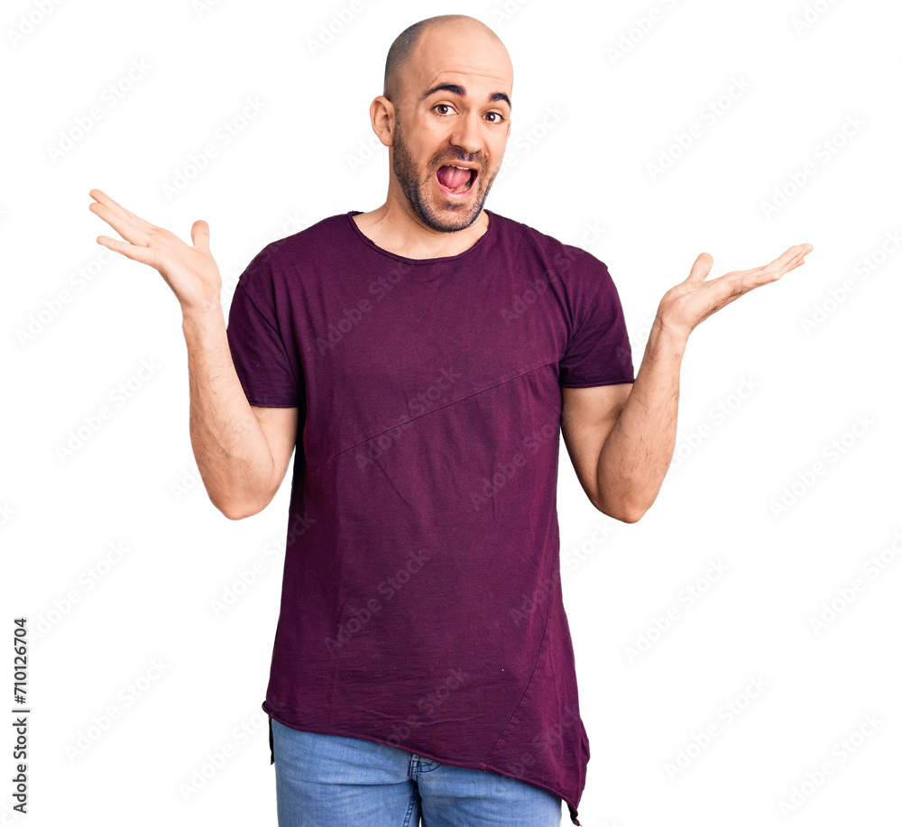 Young handsome man wearing casual t shirt celebrating victory with happy smile and winner expression with raised hands Young handsome man wearing casual t shirt celebrating victory with happy smile and winner expression with raised hands
