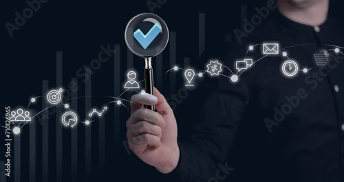 Businessman holding a magnifying glass, Audit Document concept,quality assessment management With a checklist, analysis and consulting.