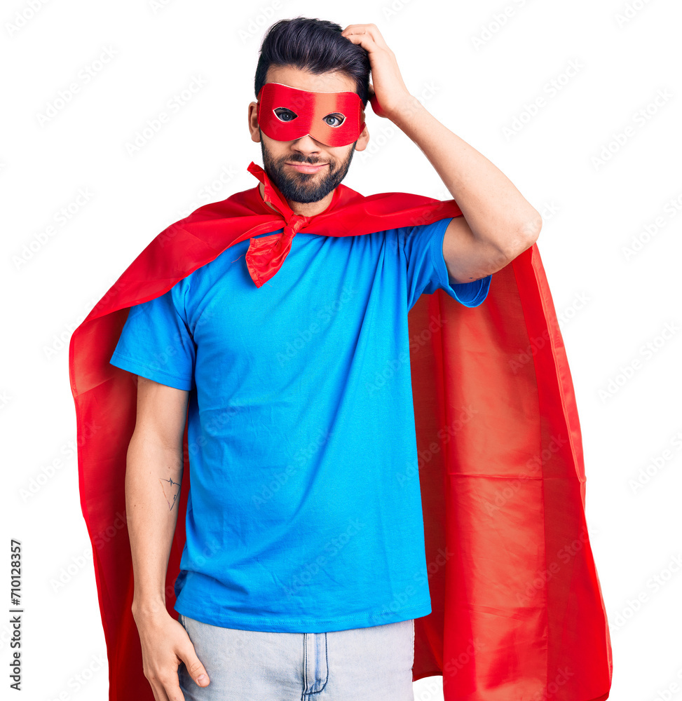 Young handsome man with beard wearing super hero costume confuse and wonder about question. uncertain with doubt, thinking with hand on head. pensive concept. Young handsome man with beard wearing super hero costume confuse and wonder about question. uncertain with doubt, thinking with hand on head. pensive concept.