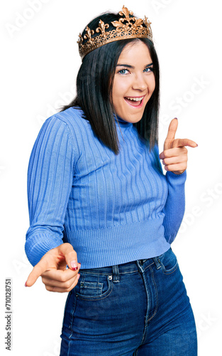 Photography Young brunette woman with blue eyes wearing princess crown pointing fingers to camera with happy and funny face