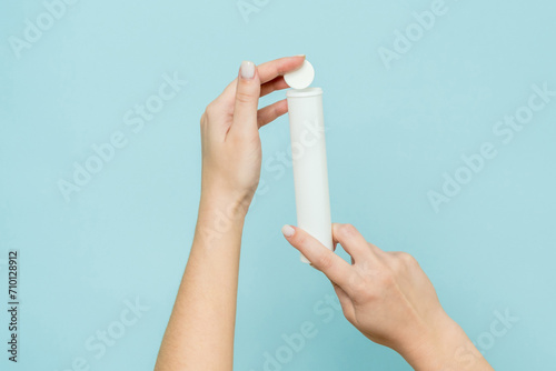 Packaging for vitamins  pills with tablet in hand. White tube. Mockup