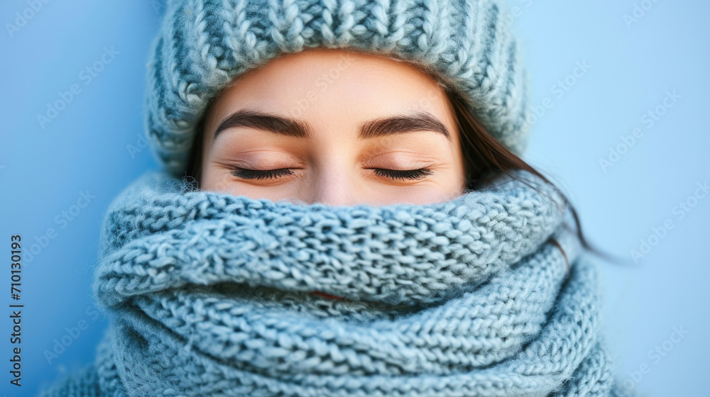 Woman wearing knitted hat and scarf. Can be used for winter fashion or cold weather concepts. Woman wearing knitted hat and scarf. Can be used for winter fashion or cold weather concepts.