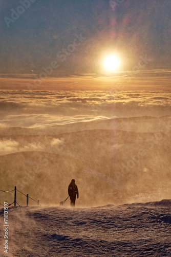 Lonely person during sunrise in the mountains. © fotogutek