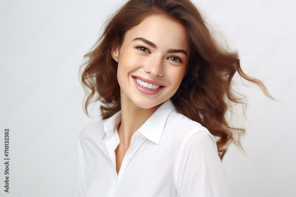 Woman wearing white shirt with bright smile on her face. Perfect for showing positivity and happiness. Ideal for websites, blogs, or social media posts. Woman wearing white shirt with bright smile on her face. Perfect for showing positivity and happiness. Ideal for websites, blogs, or social media posts.