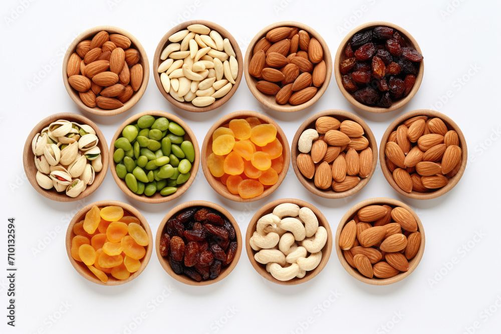 Various nuts displayed in wooden bowls on white surface. Great for food and nutrition-related projects. Various nuts displayed in wooden bowls on white surface. Great for food and nutrition-related projects.