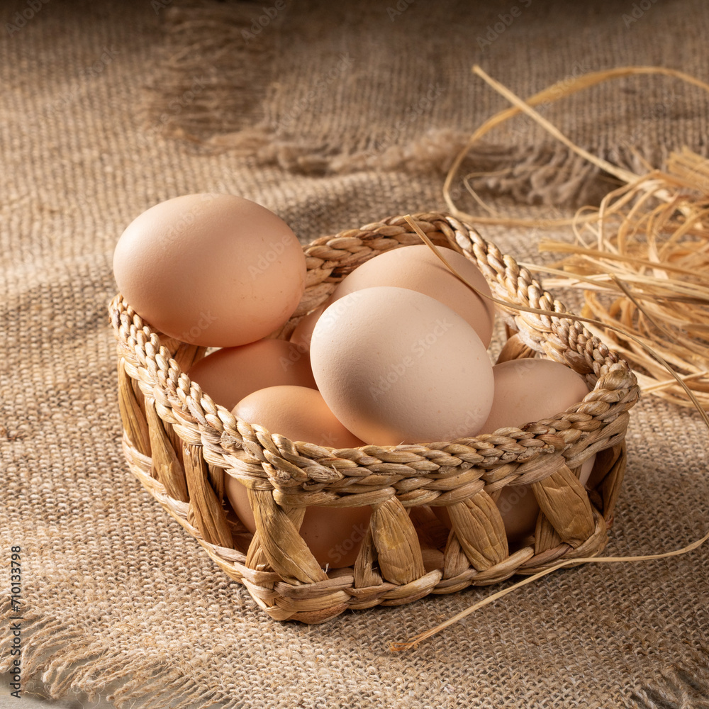 Homestead scene: chicken eggs on rural table covered with burlap cloth Homestead scene: chicken eggs on rural table covered with burlap cloth