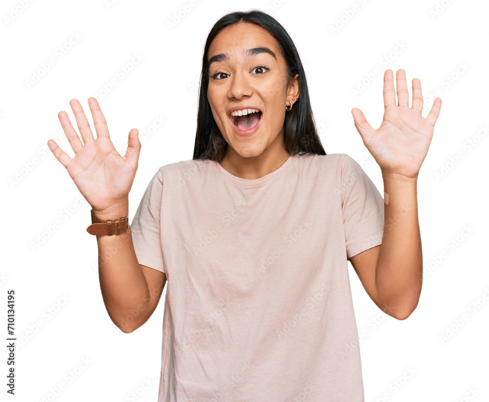 Young asian woman wearing casual clothes showing and pointing up with fingers number ten while smiling confident and happy. Young asian woman wearing casual clothes showing and pointing up with fingers number ten while smiling confident and happy.