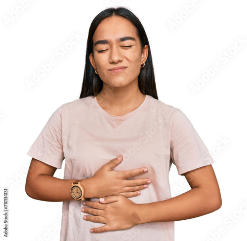 Young asian woman wearing casual clothes with hand on stomach because indigestion, painful illness feeling unwell. ache concept.