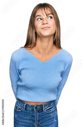 Teenager caucasian girl wearing casual clothes smiling looking to the side and staring away thinking.